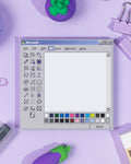 A memo pad featuring a Paint inspired design on a purple backdrop with stationery items.