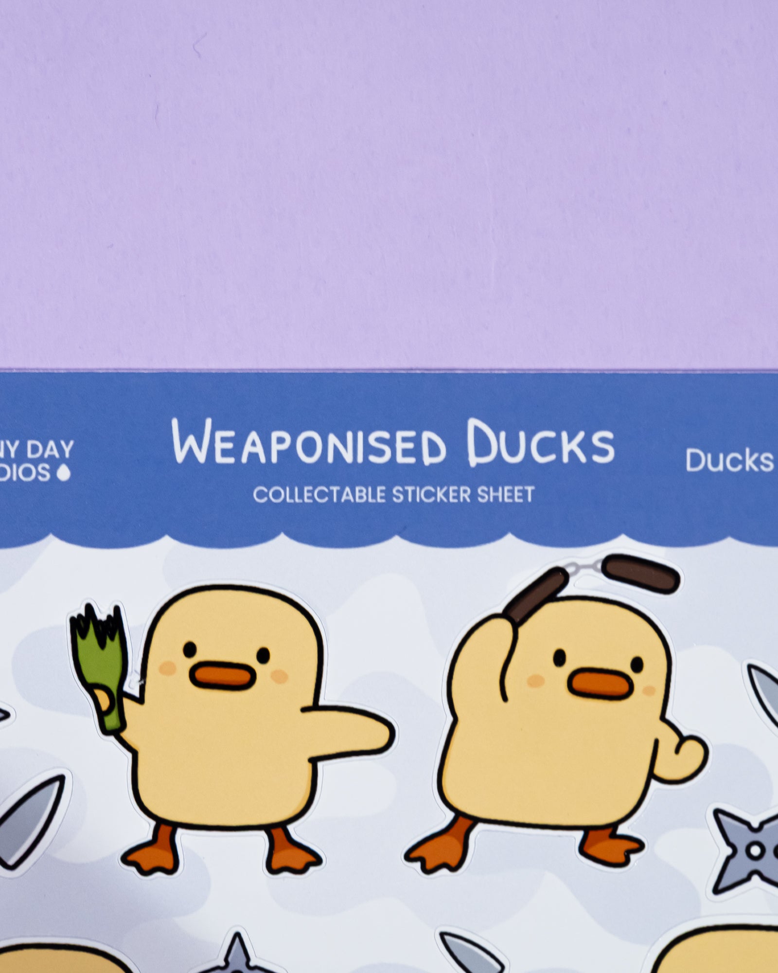 Collectible sticker sheet of 'Weaponised Ducks' with cartoon ducks on a light purple background.
