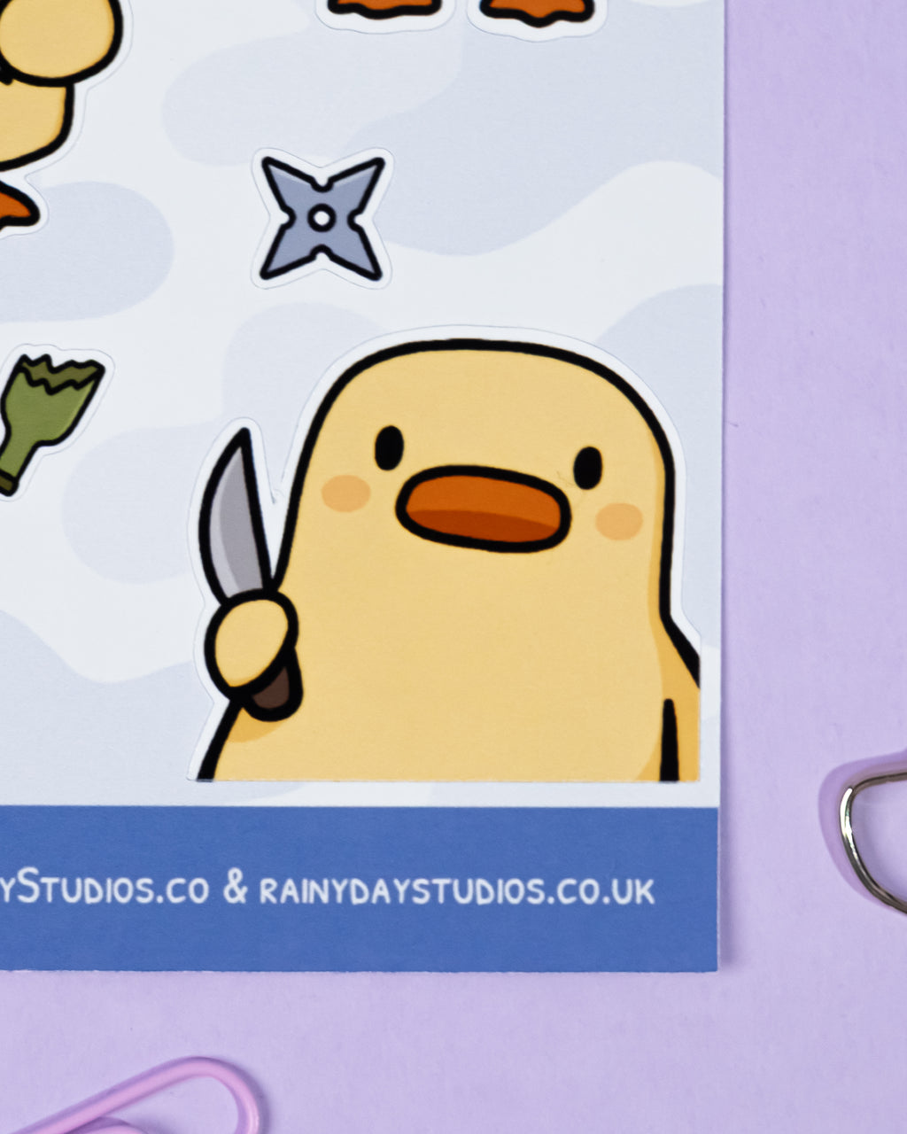 Cartoon character holding a knife on a purple background with 'RainyDayStudios.co' branding.